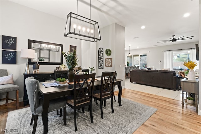 dining area featuring recessed lighting, baseboards, wood finished floors, and ceiling fan with notable chandelier