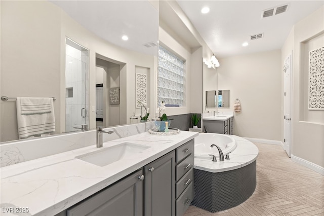 bathroom featuring a sink, visible vents, a garden tub, and a stall shower