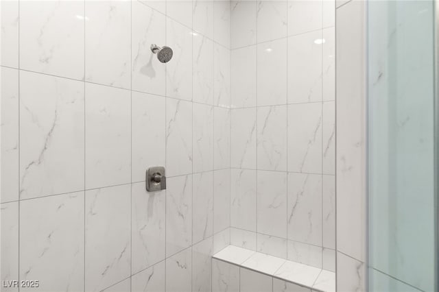 bathroom with tiled shower