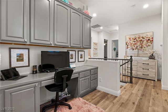 office area with baseboards, visible vents, built in study area, recessed lighting, and light wood-type flooring