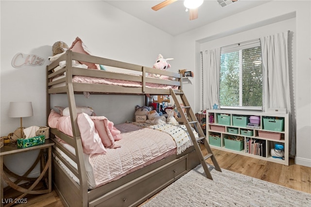 bedroom with ceiling fan and wood finished floors