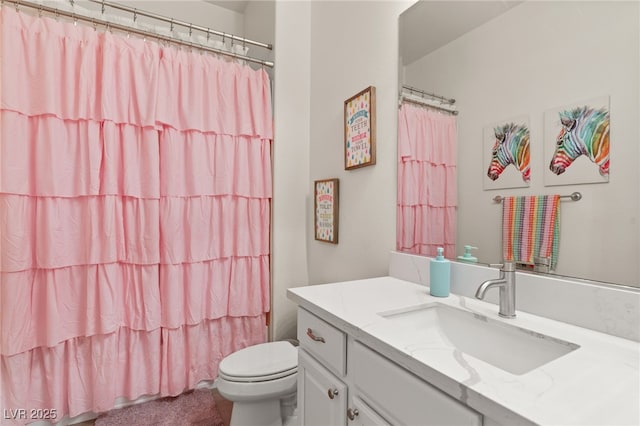 bathroom featuring vanity, a shower with shower curtain, and toilet