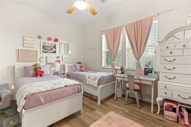 bedroom with a ceiling fan and wood finished floors