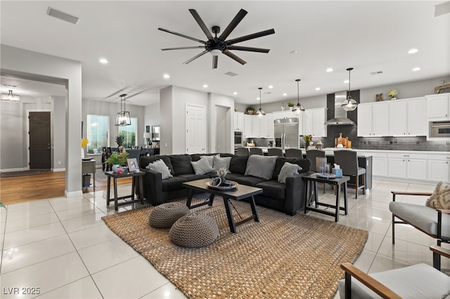 living room with light tile patterned floors, recessed lighting, visible vents, and ceiling fan