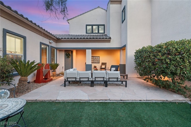 patio terrace at dusk featuring an outdoor hangout area