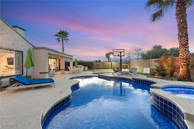 view of pool featuring outdoor dining space, a patio area, fence, and a pool with connected hot tub