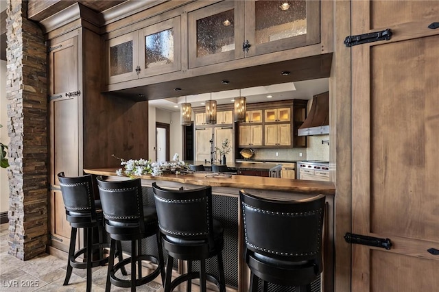 64 Promontory Ridge Dr, Las Vegas, NV 89135 - bar area with custom exhaust hood, light stone finish flooring, hanging light fixtures, a sink, and backsplash