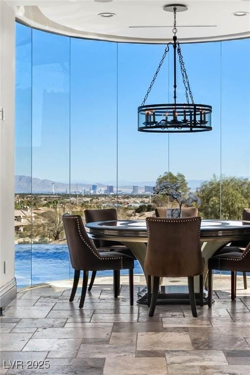 dining room featuring a notable chandelier and expansive windows