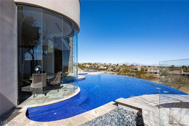 64 Promontory Ridge Dr, Las Vegas, NV 89135 - view of swimming pool with an infinity pool, a patio area, and a hot tub