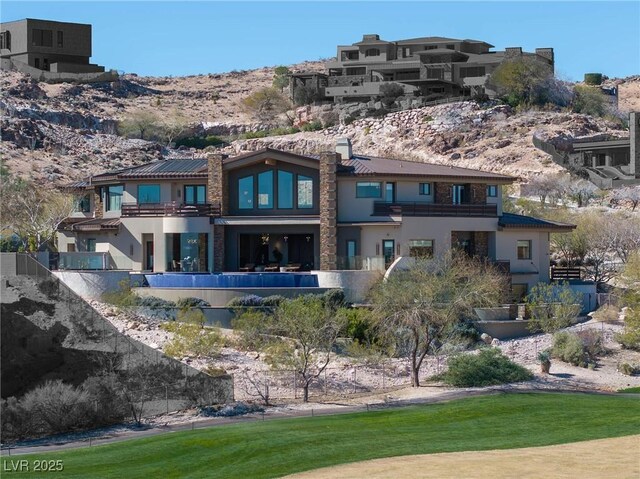 64 Promontory Ridge Dr, Las Vegas, NV 89135 - back of house featuring stucco siding and a mountain view