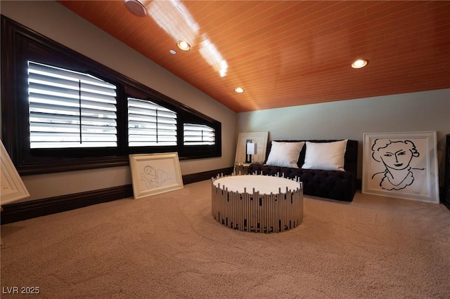 bedroom with multiple windows, wood ceiling, light colored carpet, and baseboards