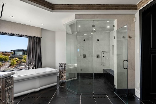 bathroom with tile patterned floors, a stall shower, and a freestanding bath