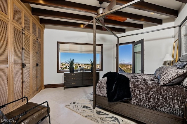 bedroom featuring tile patterned flooring, beam ceiling, and baseboards