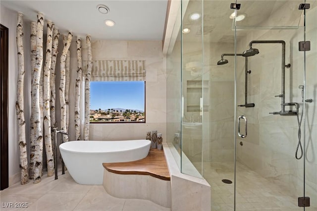 full bath with tile patterned flooring, a stall shower, and a freestanding bath