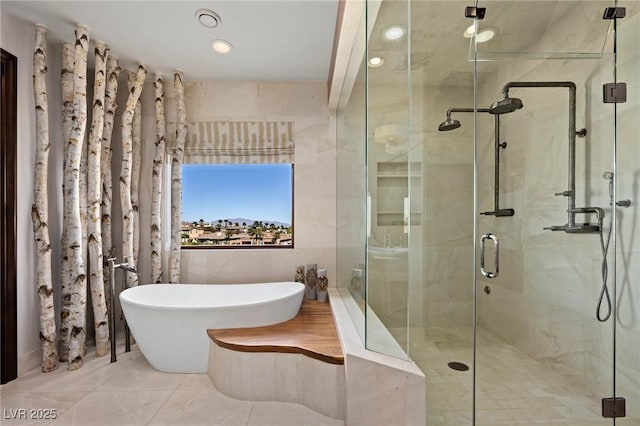 64 Promontory Ridge Dr, Las Vegas, NV 89135 - bathroom with a freestanding tub, a shower stall, and tile walls