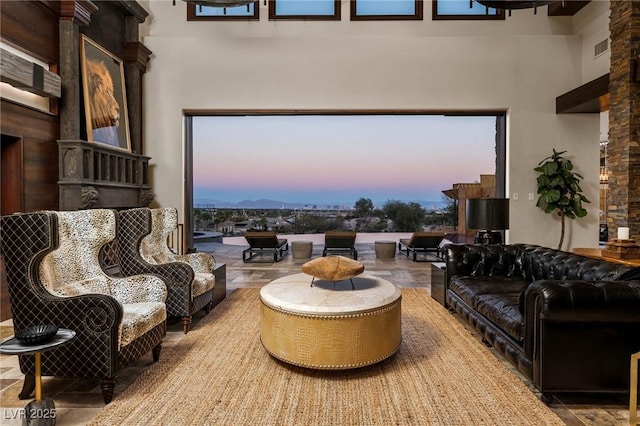 living area with a high ceiling and visible vents