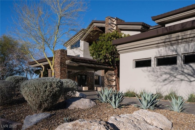 view of side of property featuring stucco siding