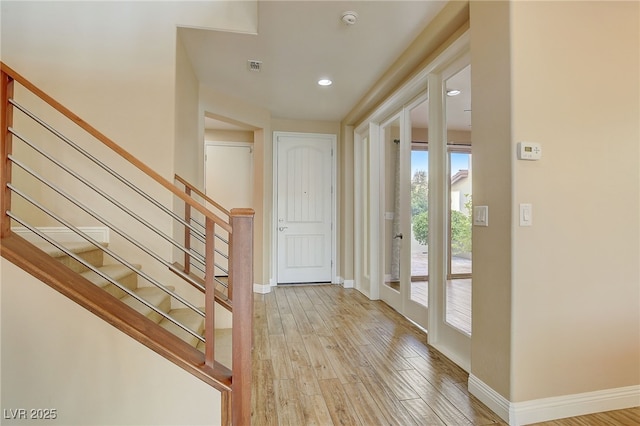 foyer with recessed lighting, stairway, baseboards, and light wood-style flooring