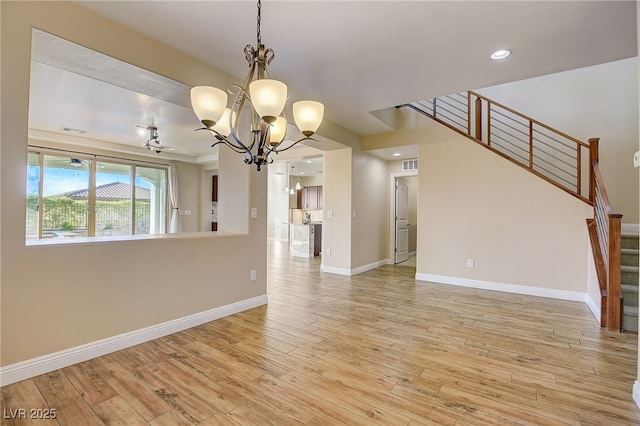 interior space with visible vents, baseboards, light wood-type flooring, stairs, and a notable chandelier