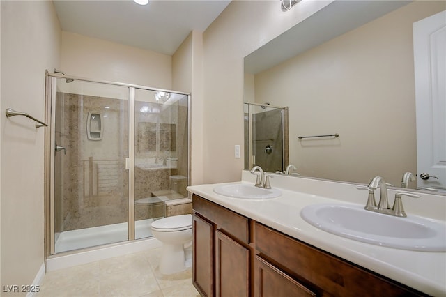 full bathroom featuring tile patterned floors, toilet, a shower stall, and a sink