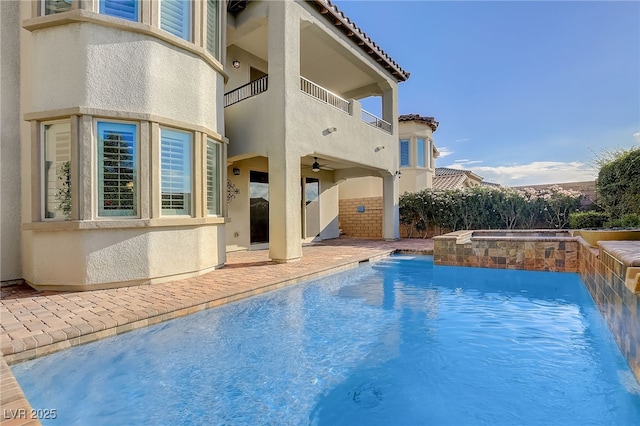 view of swimming pool with a fenced in pool, an in ground hot tub, a ceiling fan, and a patio