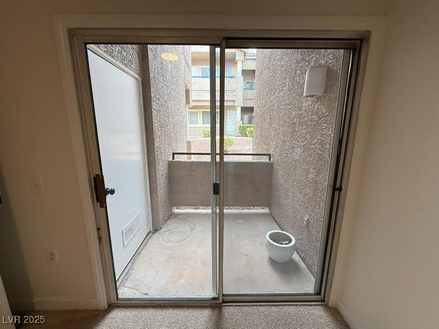 doorway to outside with visible vents and baseboards