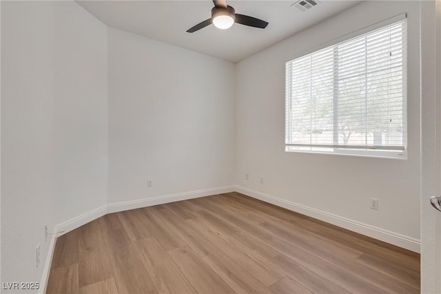 unfurnished room with light wood-style flooring, baseboards, visible vents, and ceiling fan