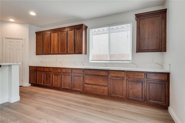 kitchen featuring recessed lighting, baseboards, light countertops, and light wood-style floors