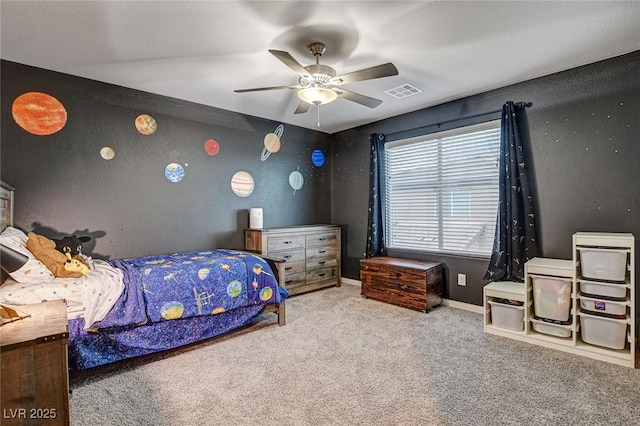 carpeted bedroom with a ceiling fan, visible vents, and baseboards