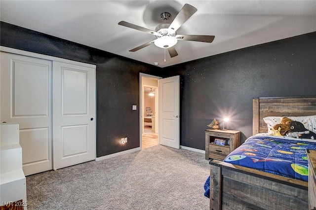 carpeted bedroom featuring a ceiling fan, baseboards, and a closet