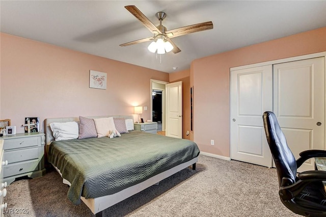 carpeted bedroom featuring a closet, baseboards, and ceiling fan