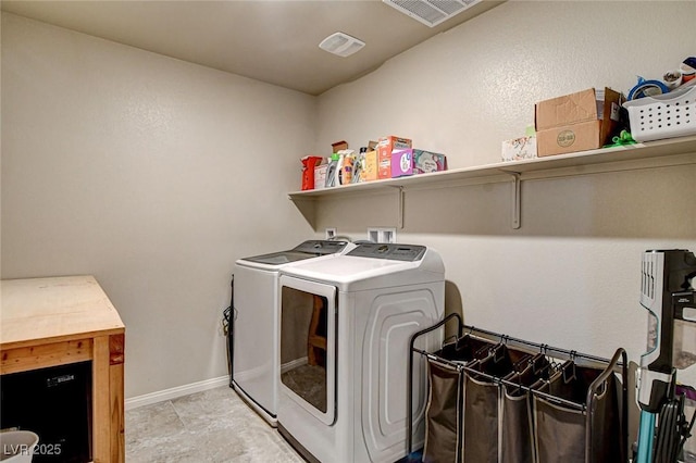 clothes washing area featuring laundry area, baseboards, visible vents, and separate washer and dryer