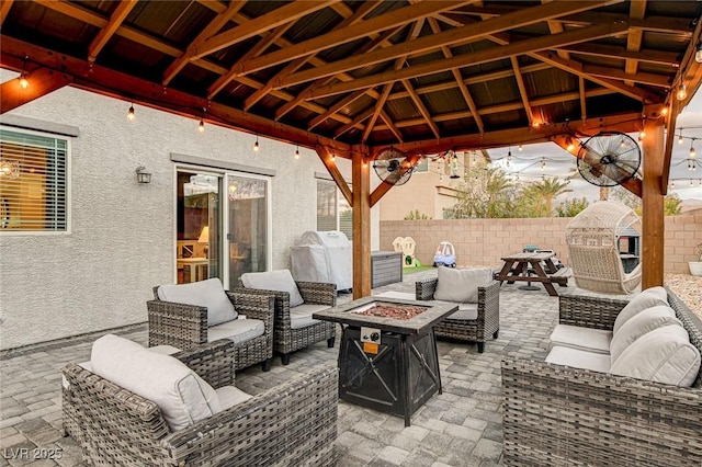 view of patio featuring an outdoor living space with a fire pit, a gazebo, and fence