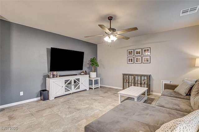 living room with visible vents, baseboards, and ceiling fan