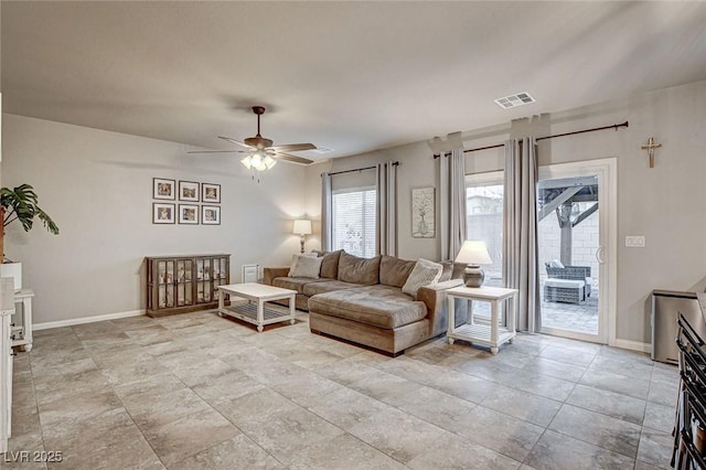 living room featuring visible vents, baseboards, and ceiling fan