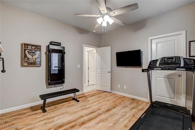 workout room featuring baseboards, light wood-style floors, and ceiling fan