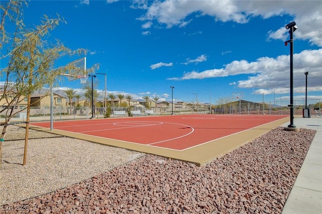 view of sport court with a residential view, community basketball court, and fence