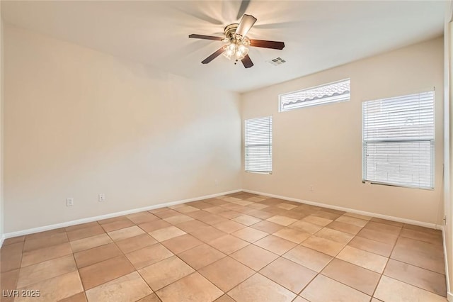 unfurnished room with light tile patterned floors, visible vents, baseboards, and ceiling fan