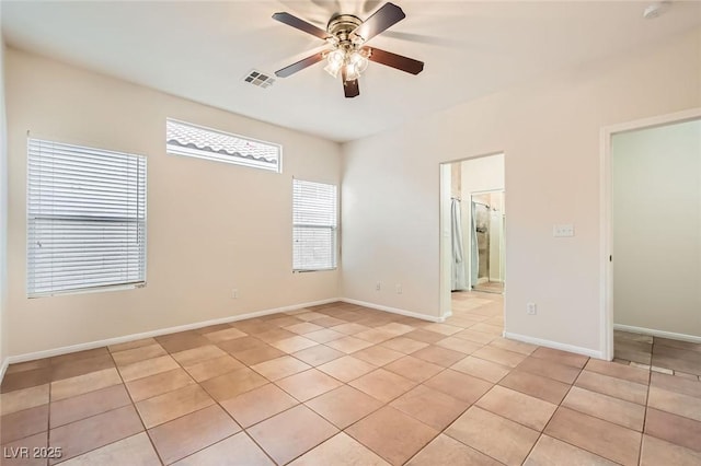 spare room with light tile patterned flooring, visible vents, baseboards, and ceiling fan