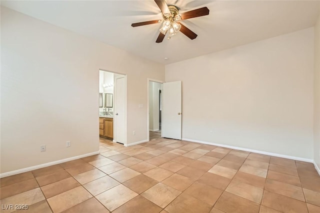 spare room with light tile patterned floors, baseboards, and ceiling fan