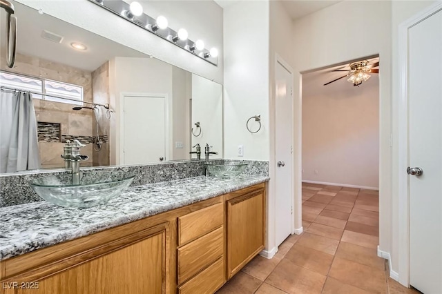 bathroom with tile patterned floors, double vanity, and a sink