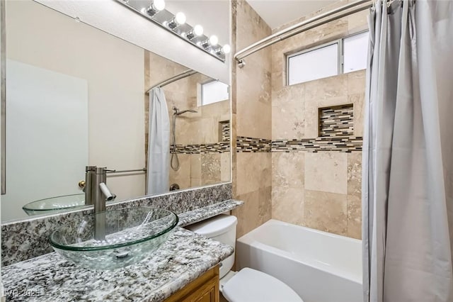 bathroom featuring vanity, toilet, and shower / tub combo with curtain