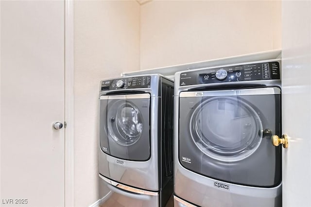 washroom with washer and clothes dryer and laundry area