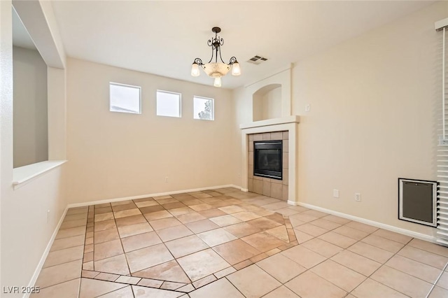 unfurnished living room featuring light tile patterned floors, baseboards, visible vents, and a tile fireplace