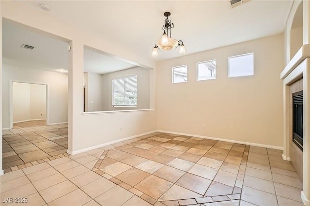 interior space featuring light tile patterned floors, baseboards, and visible vents