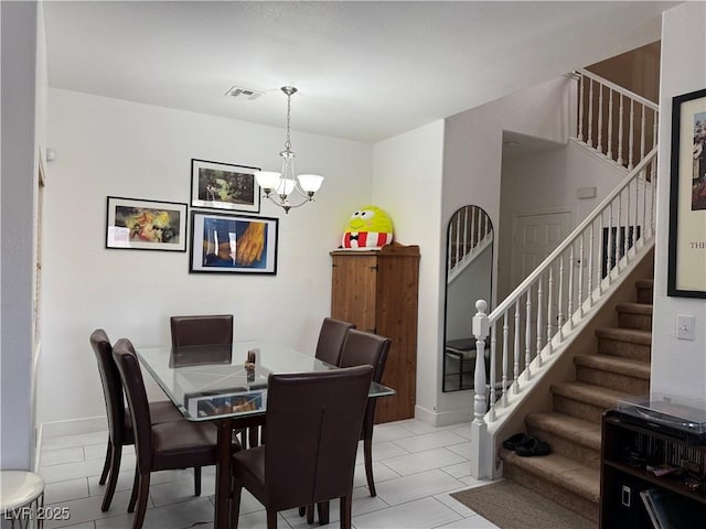 dining room with a notable chandelier, visible vents, stairway, and baseboards