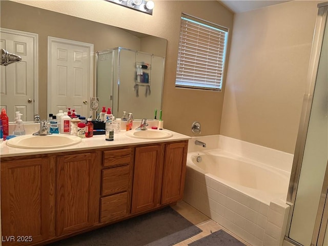 bathroom with a garden tub, a stall shower, and a sink