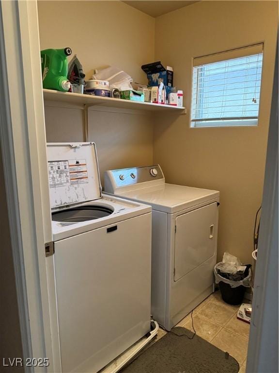 laundry area with light tile patterned floors, laundry area, and washer and clothes dryer