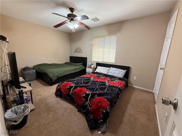 carpeted bedroom featuring visible vents, ceiling fan, and baseboards