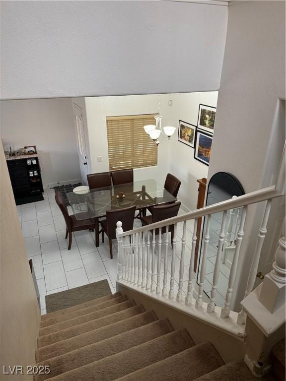 stairway with a chandelier